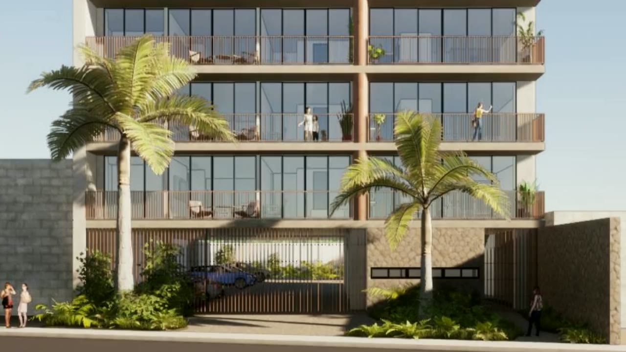 Recorrido por Quartier: la fachada de la torre, la sala del departamento muestra y la vista desde el rooftop hacia la bahía